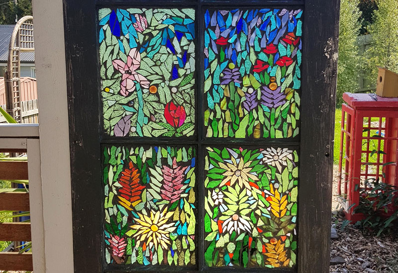Beautiful wildflower upcycled glass mosaic on secondhand door by Lisa Gill